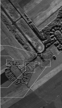 Grayscale targeting view of vehicles and terrain